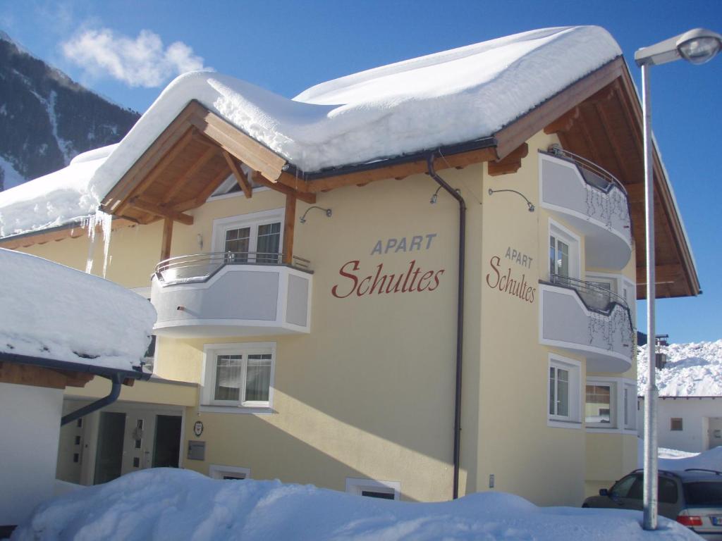 a building with snow on top of it at Apart Schultes in Pettneu am Arlberg