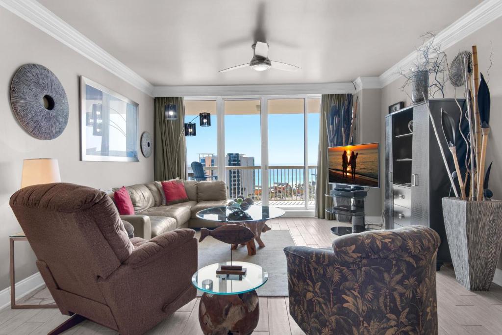 a living room with a couch and chairs and a television at St. Lucia 1103 in Destin
