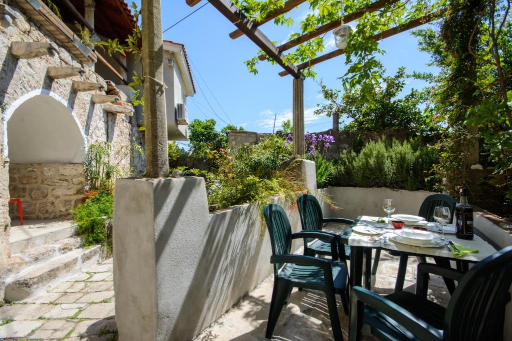 a patio with a table and chairs under a pergola at Apartment La Vida in Dubrovnik