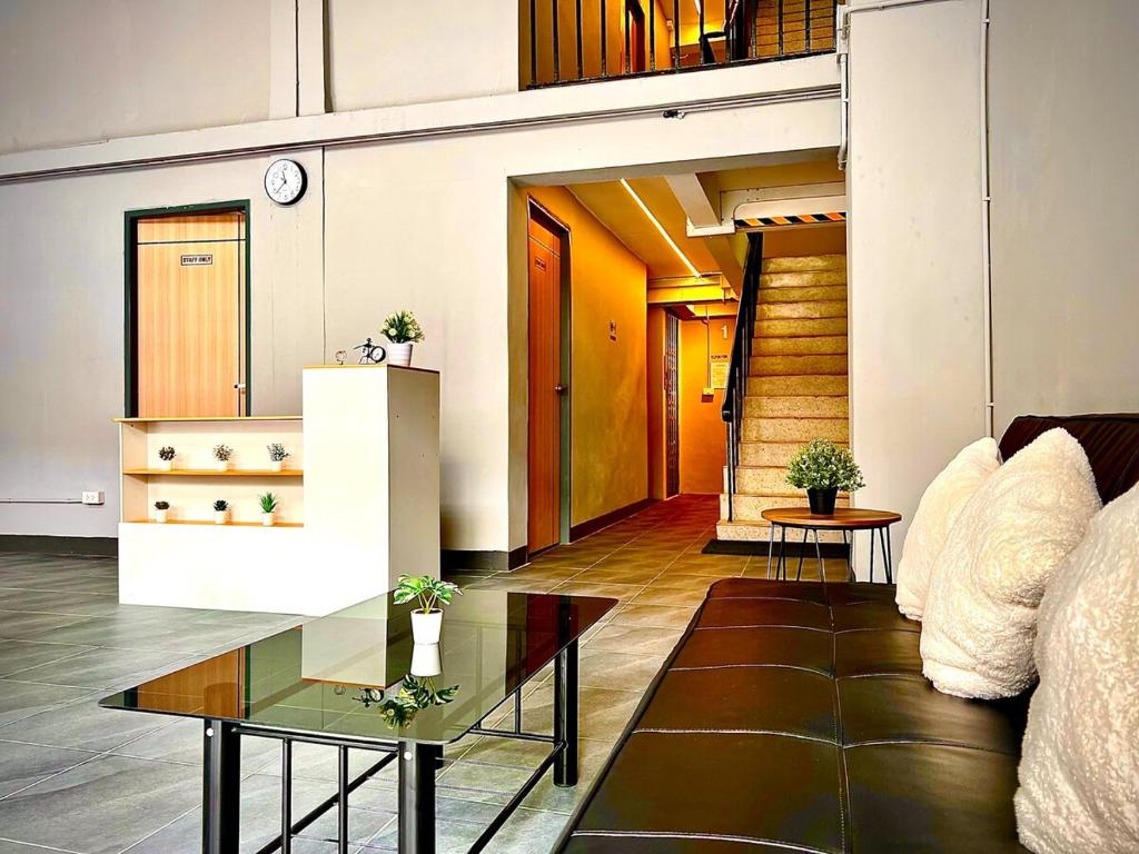 a living room with a table and a couch at The Circle 4 in Bangkok