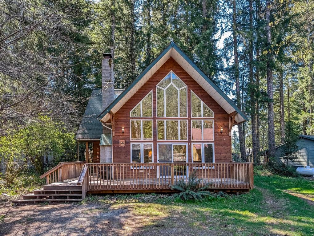 a house with a large window and a large deck at Moose Manor in Packwood