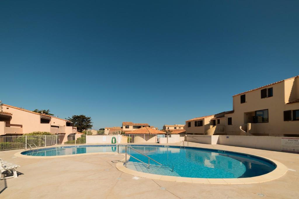 a large swimming pool in the middle of a building at Leucate Aphrodite village in Leucate