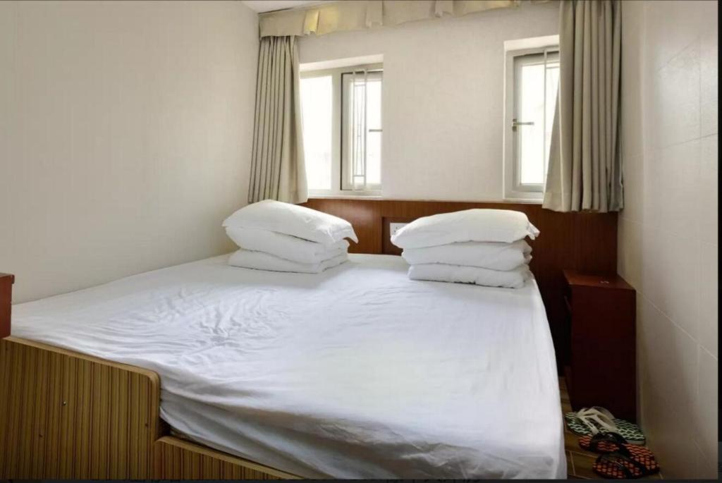 Voodi või voodid majutusasutuse 香港金門賓館 KamMun Guest House toas
