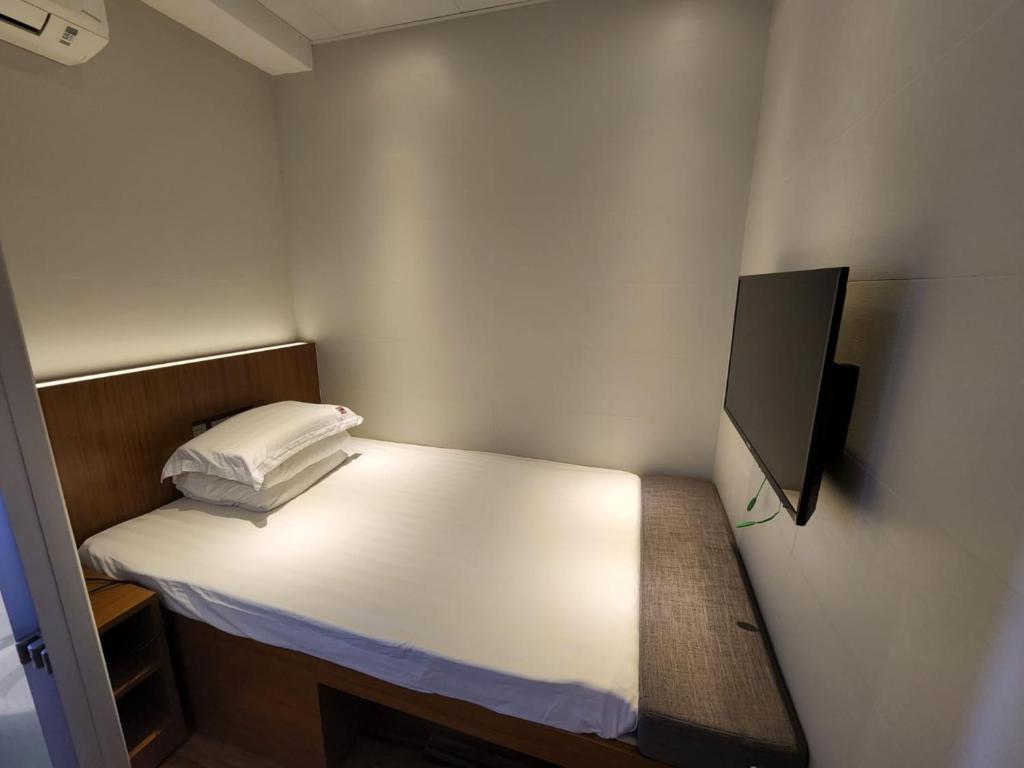 Voodi või voodid majutusasutuse 香港金門賓館 KamMun Guest House toas