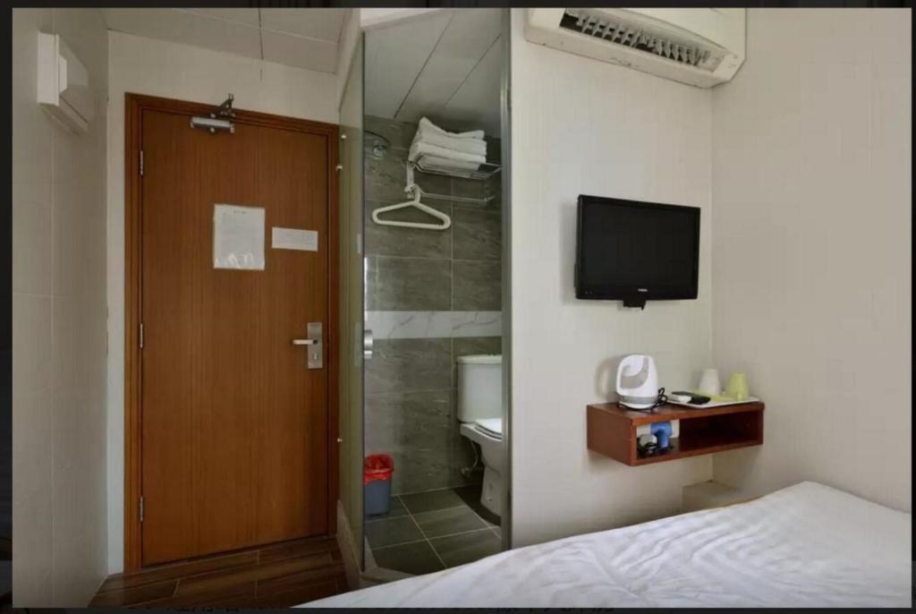 Voodi või voodid majutusasutuse 香港金門賓館 KamMun Guest House toas