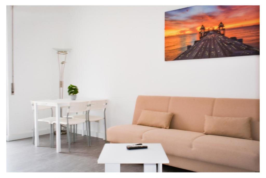 a living room with a couch and a table at Ostia Holiday Circe in Lido di Ostia
