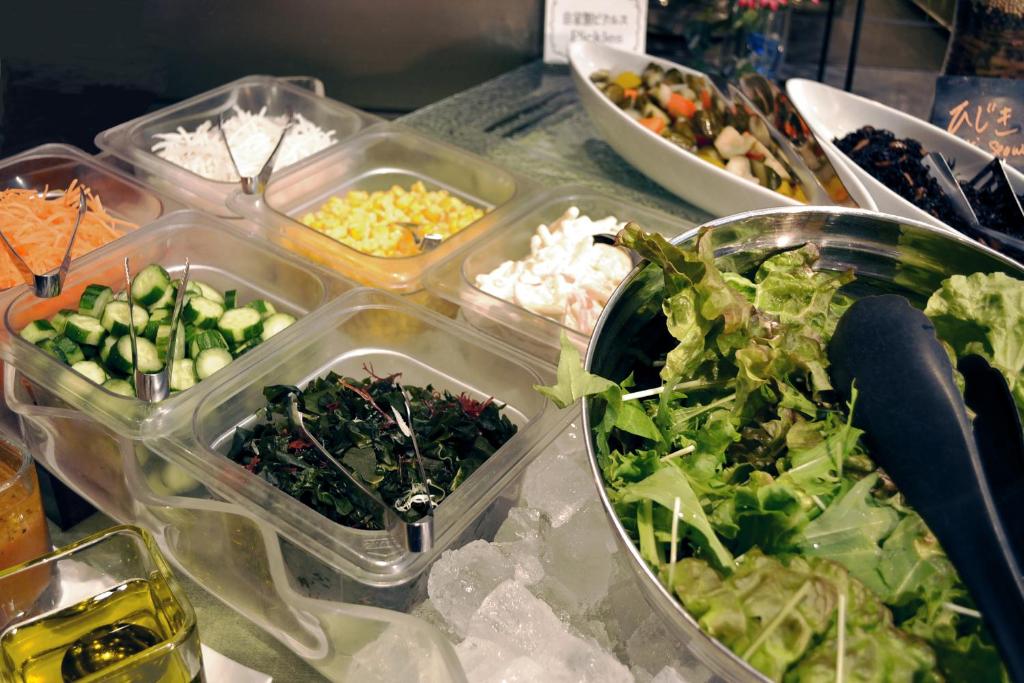 a table topped with plastic containers filled with different types of food at Citadines Central Shinjuku Tokyo in Tokyo