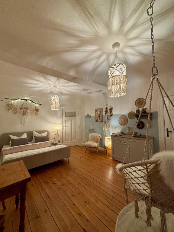 a large living room with a bed and a ceiling at Bauernhofvilla nur für Frauen Woman only in Niemegk