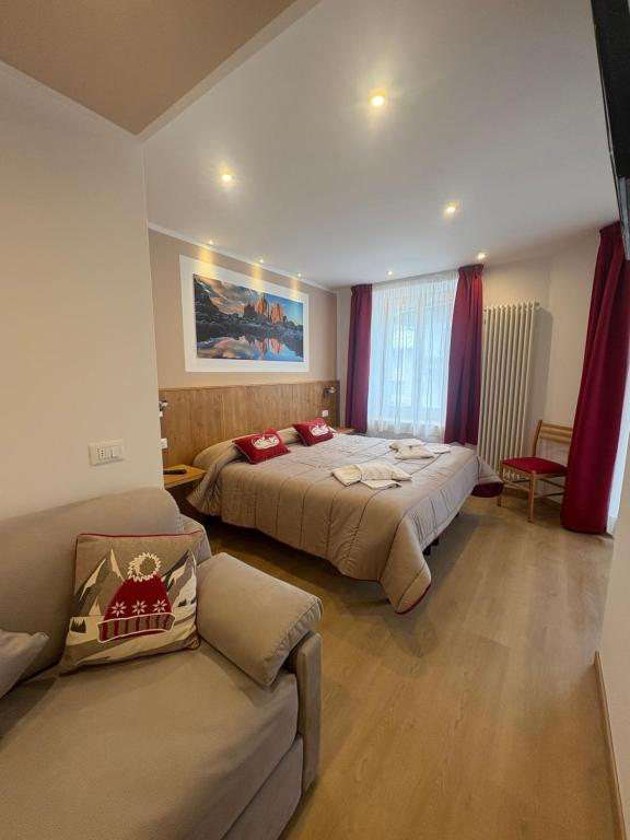 Postel nebo postele na pokoji v ubytování Albergo Vittoria