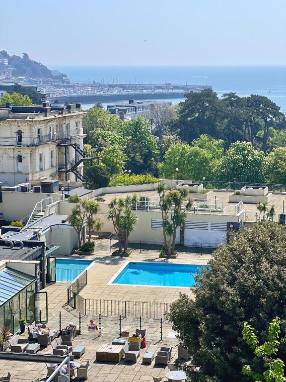 a view of a building with a swimming pool at TLH Victoria Hotel - TLH Leisure, Entertainment and Spa Resort in Torquay
