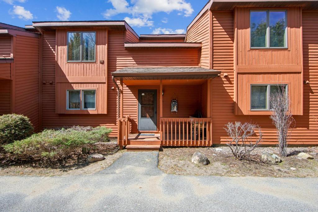 a wooden house with a porch and a driveway at Hawkeye 21E - Spacious Townhome for Families in North Creek