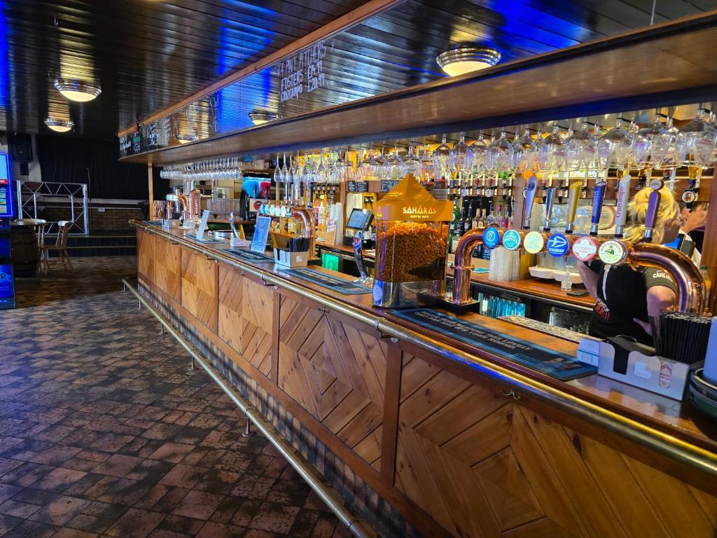 a bar with a lot of liquor bottles at Villager Hotel, Ingoldmells in Ingoldmells