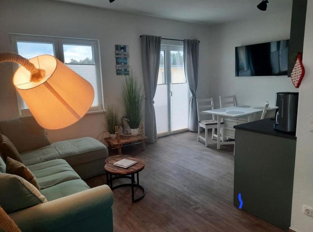 a living room with a couch and a table at Küstenwind in Graal-Müritz