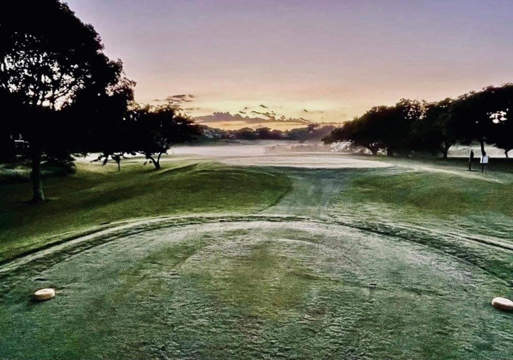 a view of a golf course with a green at Cosy Urban Apartment in Durban