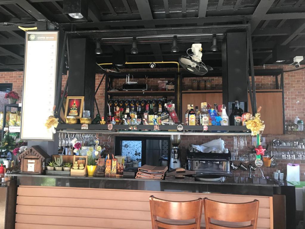 a bar in a restaurant with two chairs at David Residence in Nai Yang Beach