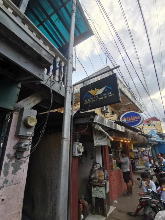 a building with a sign on the side of it at Ken's Inn in Coron