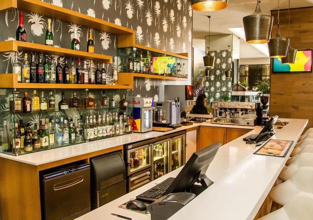 a bar with a laptop computer on a counter at Cosy Urban Apartment in Durban