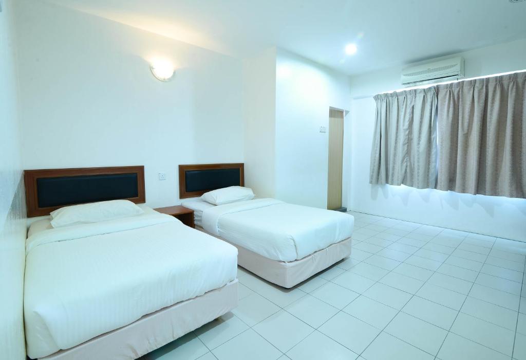 Voodi või voodid majutusasutuse Mersing Hotel toas