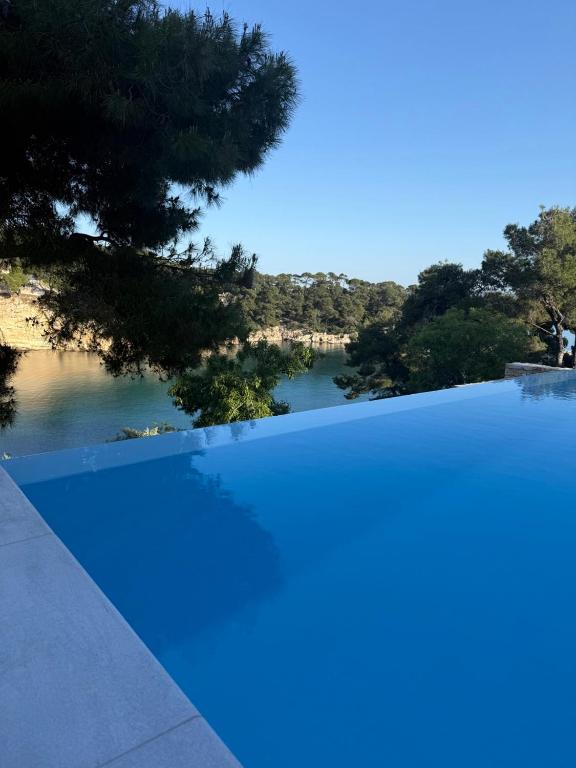 a swimming pool with a view of a body of water at D & A Land luxury house in Alonnisos