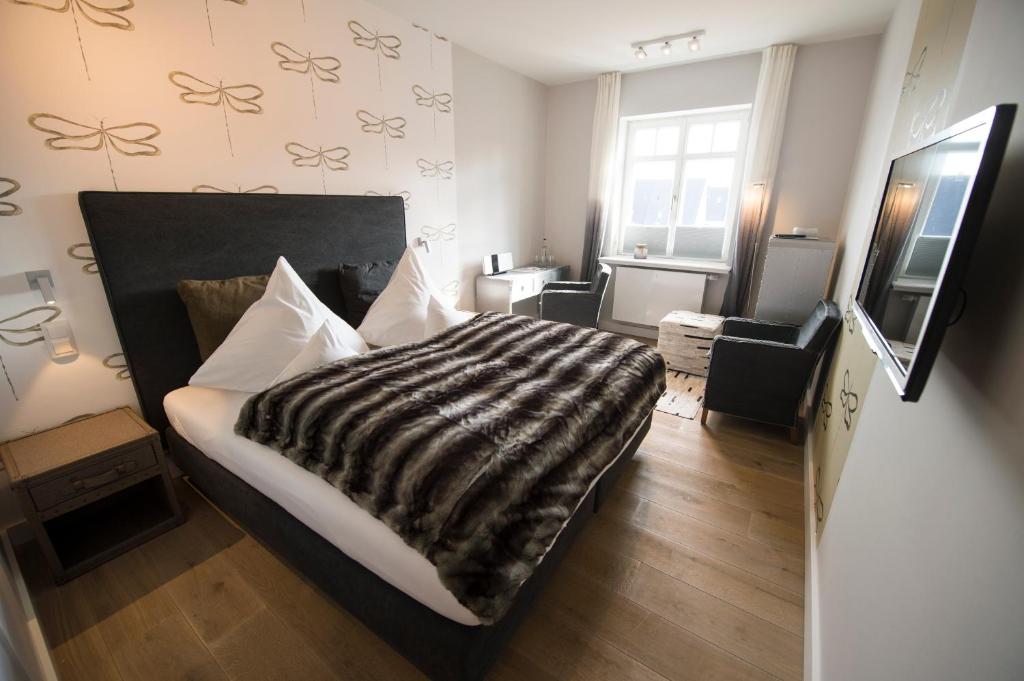 Postel nebo postele na pokoji v ubytování Das 54 Grad Nord - Apartments & More