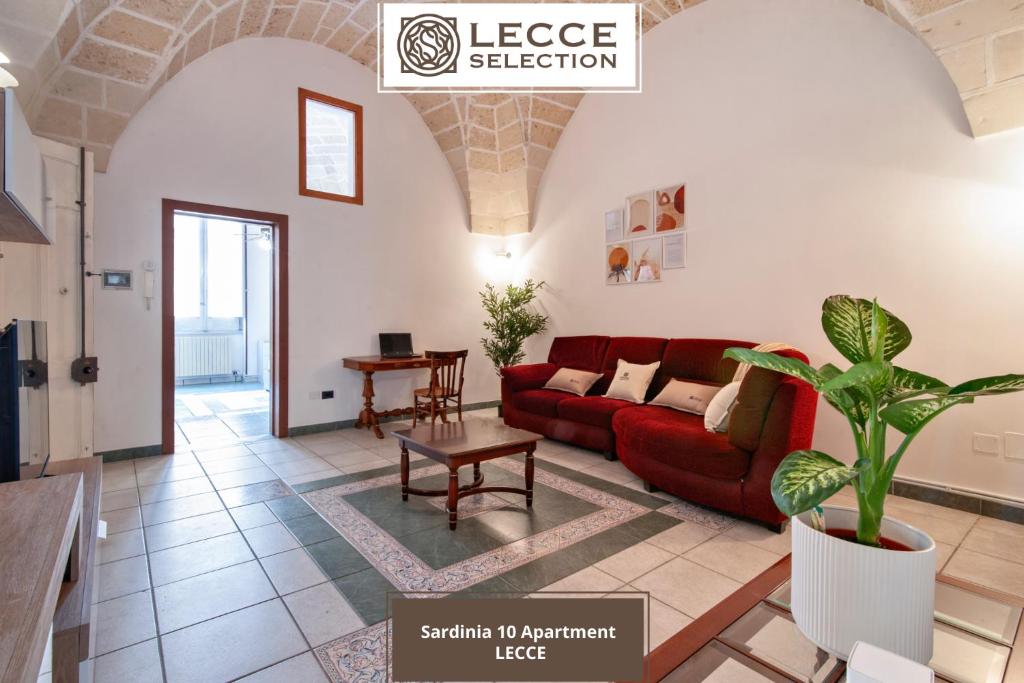 a living room with a red couch and a table at Sardinia 10 Apartment - Lecce Selection in Lecce