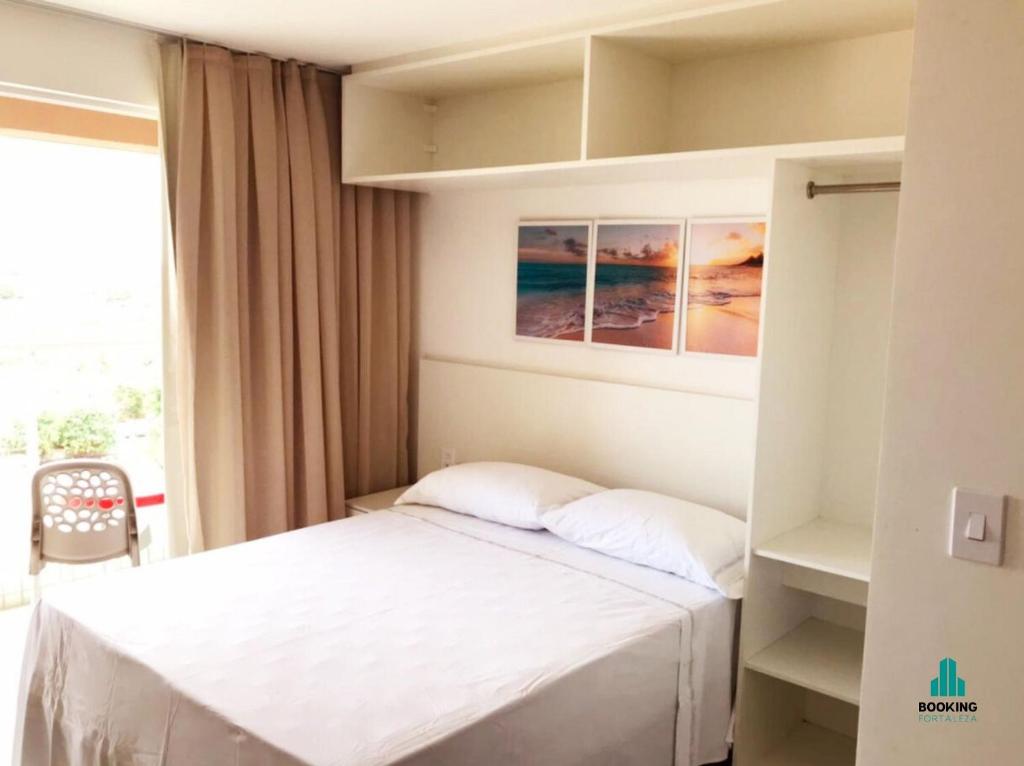 a small bedroom with a bed and a window at Fortaleza Sul Flats Service in Fortaleza