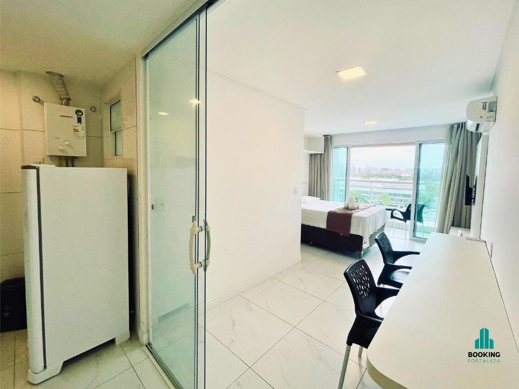 a room with a glass door leading to a bedroom at Fortaleza Sul Flats Service in Fortaleza