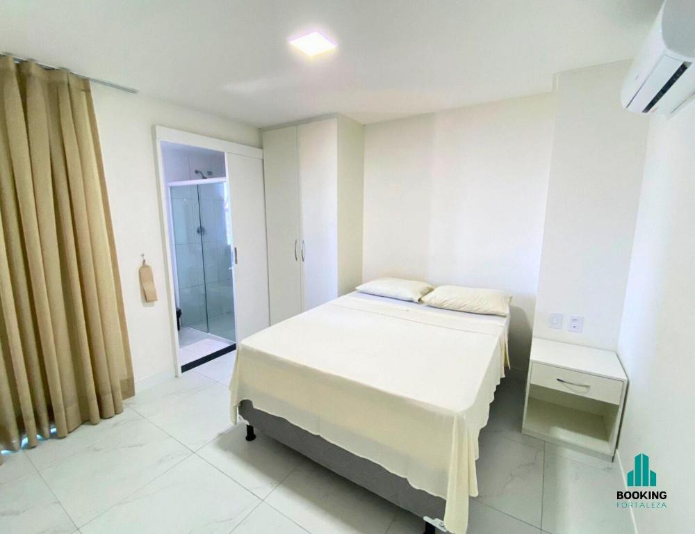 a white room with a bed and a walk in shower at Fortaleza Sul Flats Service in Fortaleza