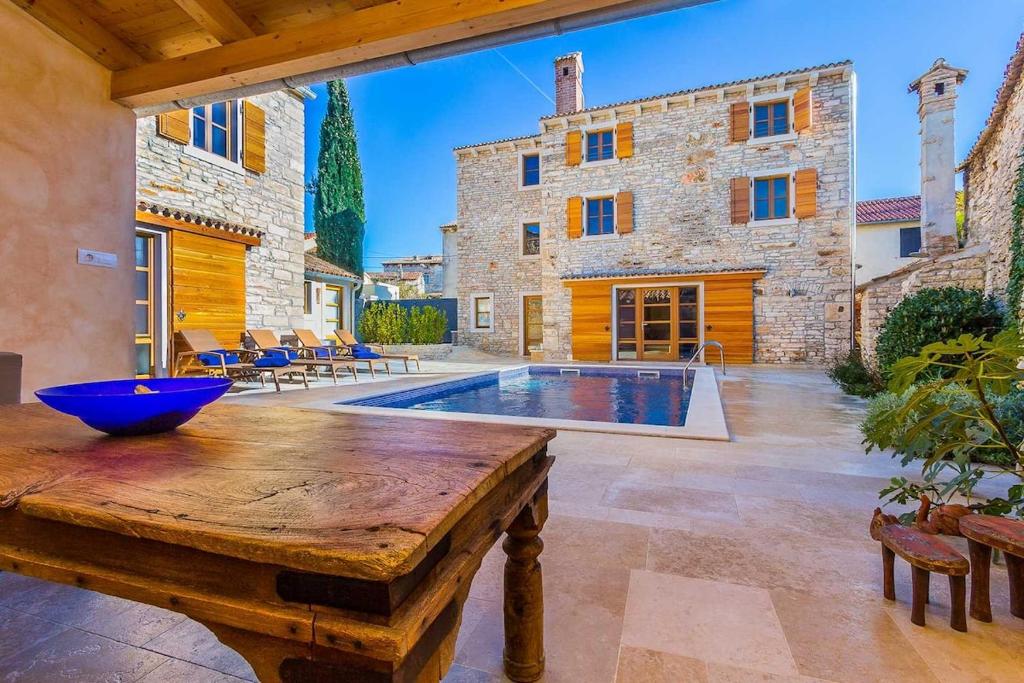 シサンにあるVilla Perla by Kompas Villasの屋外パティオ(木製テーブル、スイミングプール付)