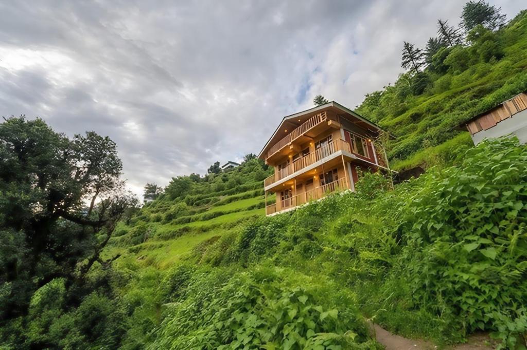 a building on the side of a hill at Perfect Home for Stay in Jibhi