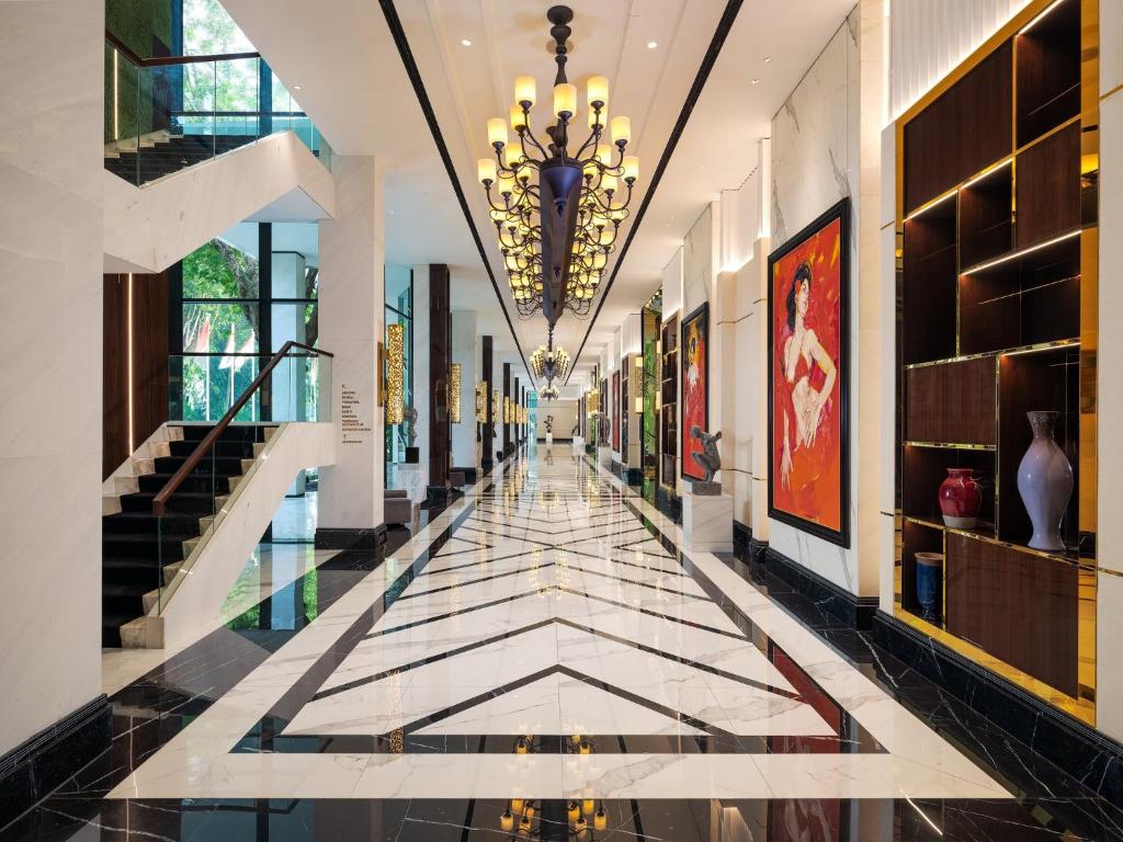 a hallway with a tile floor and a chandelier at InterContinental Bali Resort by IHG in Jimbaran