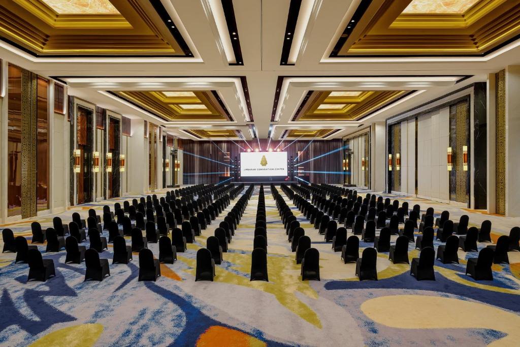 an empty conference room with chairs and a screen at InterContinental Bali Resort by IHG in Jimbaran