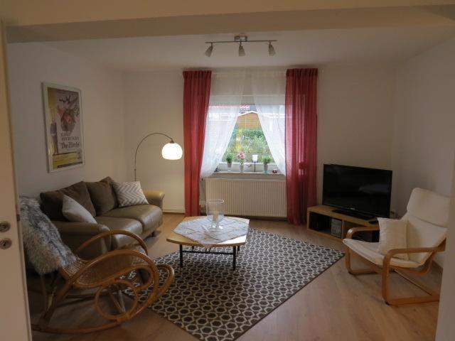 a living room with a couch and a table at Haus am Mühlbach in Lübeck