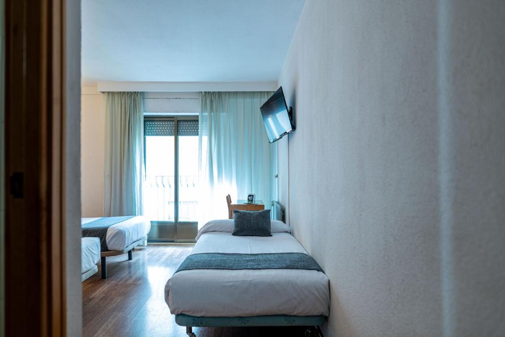 Postel nebo postele na pokoji v ubytování Hotel Alda Guijuelo