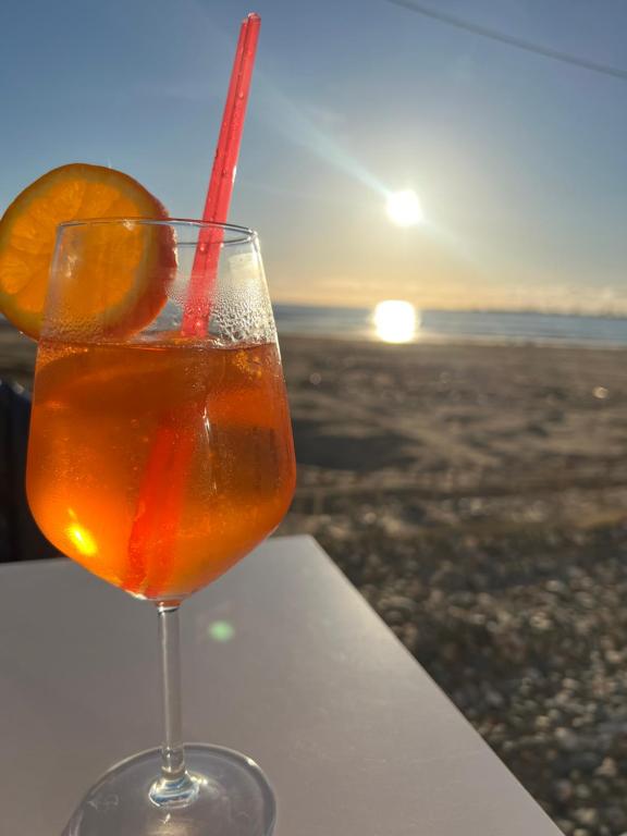 a drink in a glass sitting on a ledge with the sunset at Everest in Golem