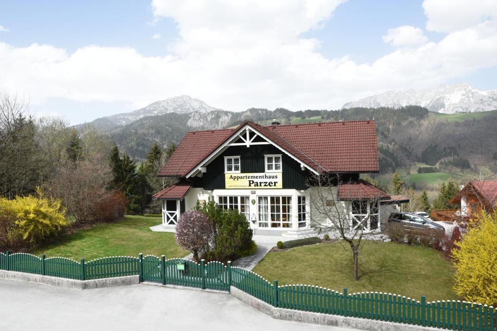 a house with a fence in front of it at Appartementhaus Parzer in Pruggern