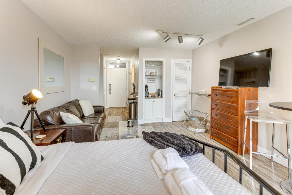 a living room with a bed and a couch at 8 Mi to Traverse City Bayside Couples Retreat in Williamsburg