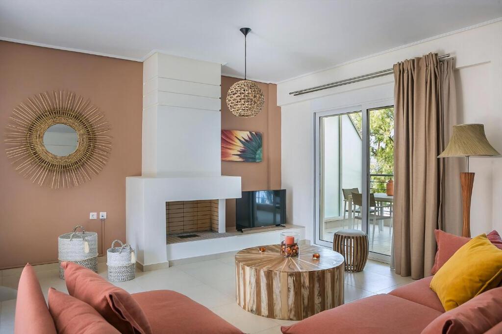 a living room with a couch and a table at Deluxe Kefalonia Apartment Apartment Corali 3 Bedroom Pool Sea View Karavomilos in Karavomylos