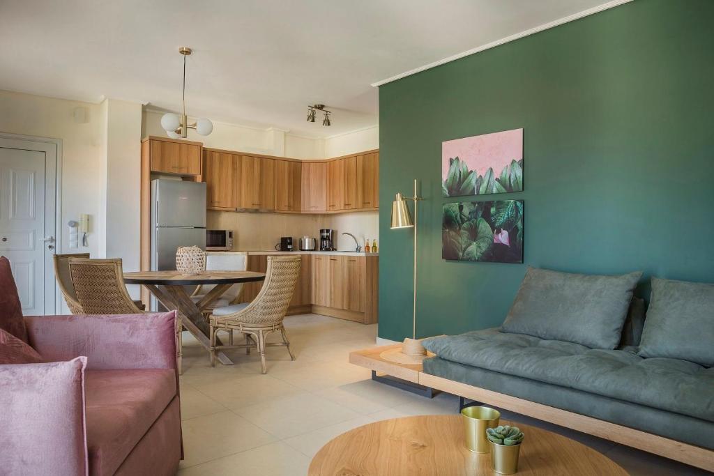 a living room with a couch and a table at Deluxe Kefalonia Apartment Apartment Noufaro 1 Bedroom Pool Sea View Karavomilos in Karavomylos