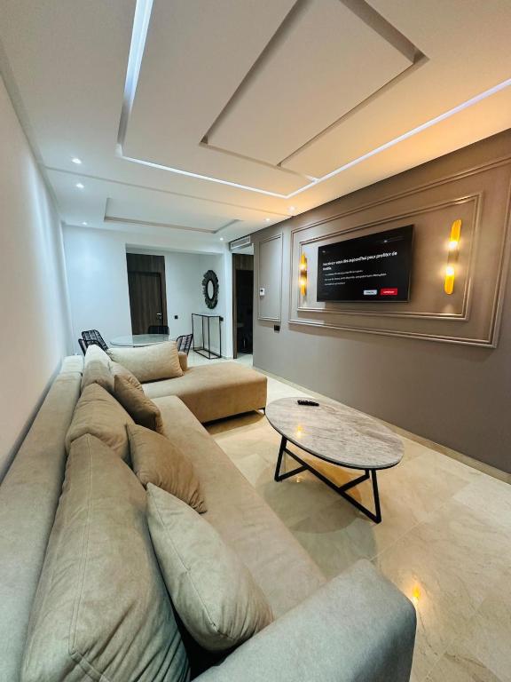 a living room with a couch and a tv at 3 bedroom apartment in Marrakesh
