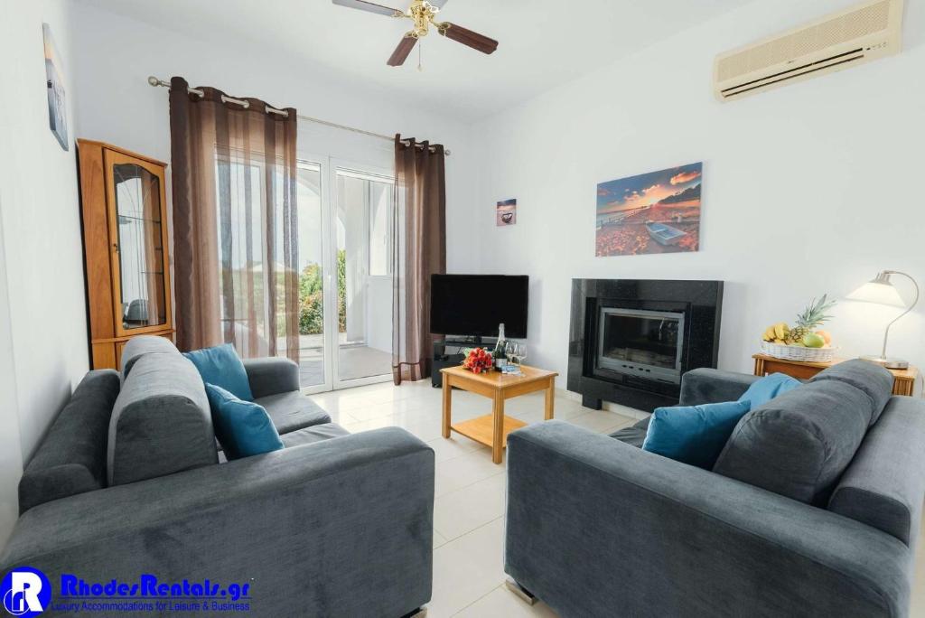A television and/or entertainment centre at Executive Rhodes Villa Villa Gennadi 2 Bedroom Villa Private Pool Sea View Gennadi