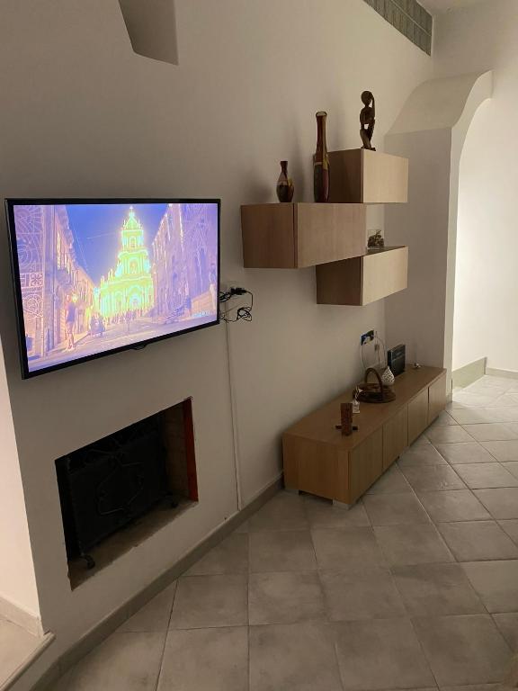 a living room with a flat screen tv on a wall at Casa Vacanze Centro Storico in Centola
