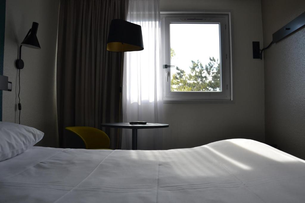 Postel nebo postele na pokoji v ubytování ibis Chambery