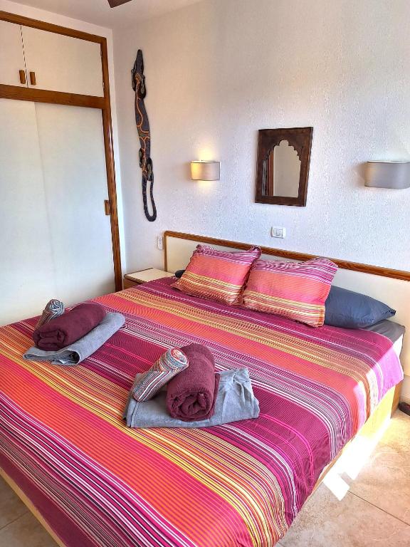 A bed or beds in a room at Casa Iguazu - At the center of Playa del Inglés