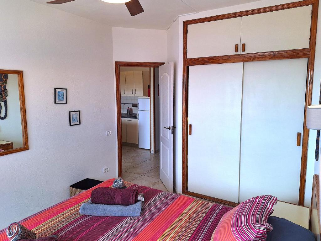 A bed or beds in a room at Casa Iguazu - At the center of Playa del Inglés