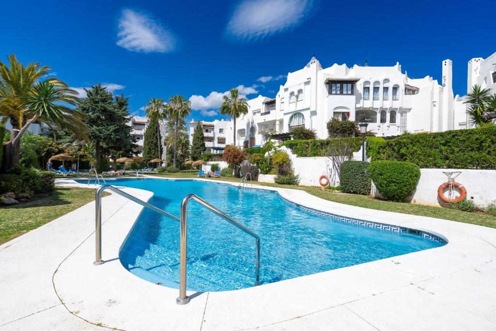 a swimming pool in front of a house at Perfect Location 2 Bed Apart Medina Del Zoco in Sitio de Calahonda