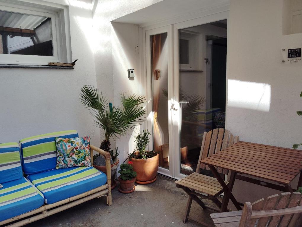 a patio with a couch and a table and chairs at Self contained private gite close to Carcassonne, rural location in Badens