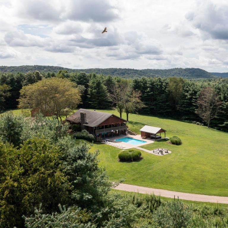 an aerial view of a house with a swimming pool at Grande Butte Lodge - by The Chalets in Laurelville