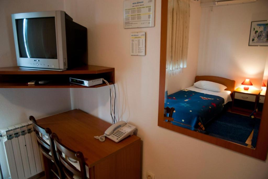 a room with a bed and a television and a phone at Hotel Metković in Metković