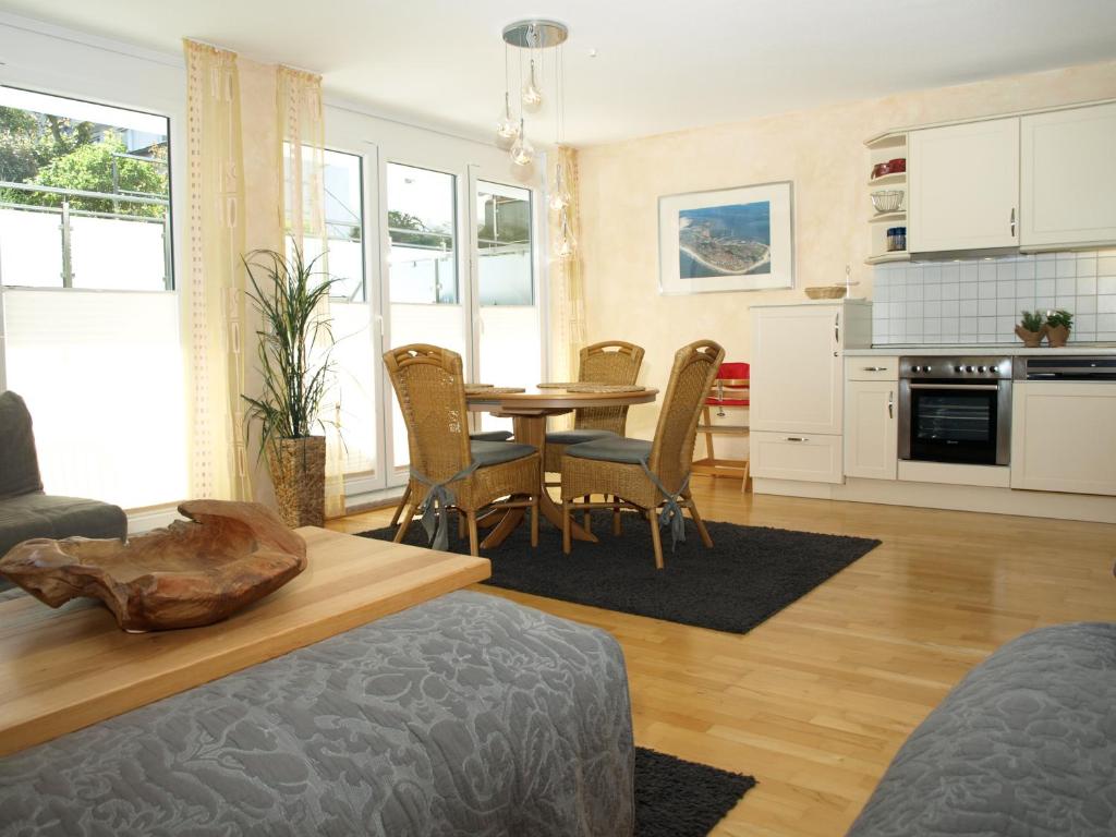 a kitchen and dining room with a table and chairs at Haus Sonnenhaken Wohnung 1 in Norderney